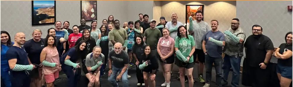 An OrthoHeal Academy training session in the USA — everyone wearing a FlexiOH