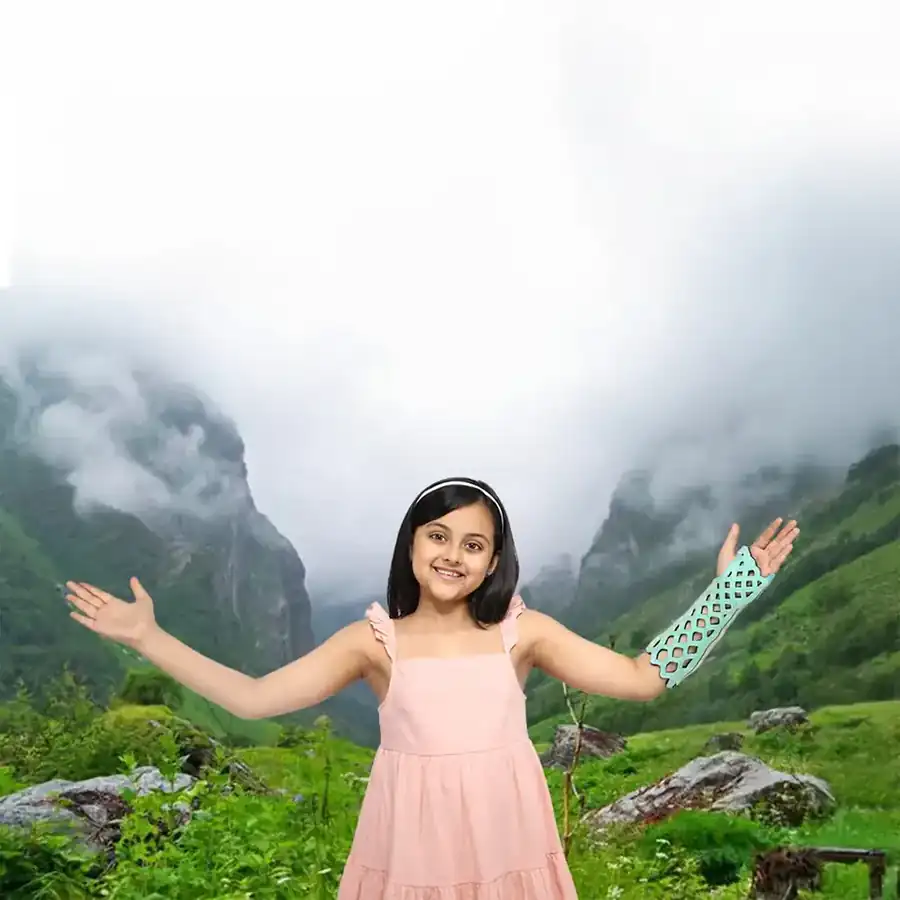 Girl with arms spread in the mountains wearing a FlexiOH arm immobilizer