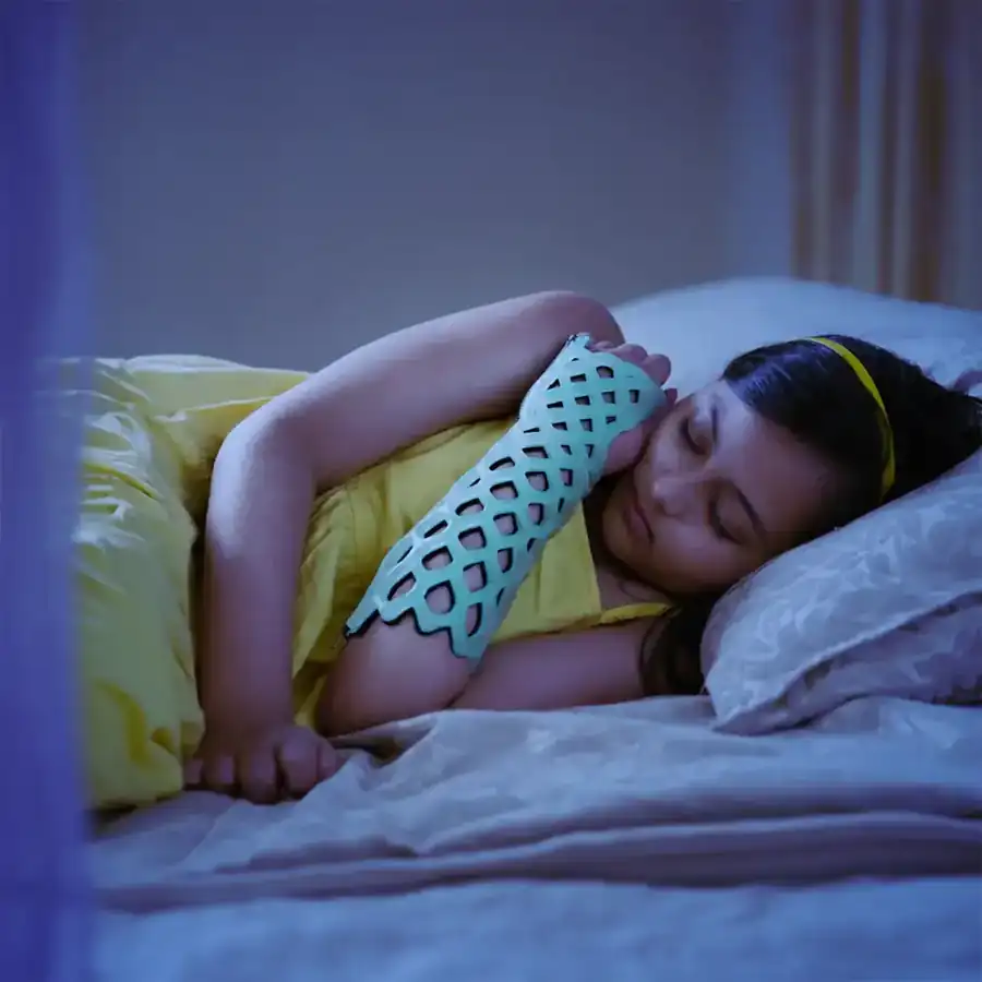Girl sleeping comfortably wearing a FlexiOH arm immobilizer