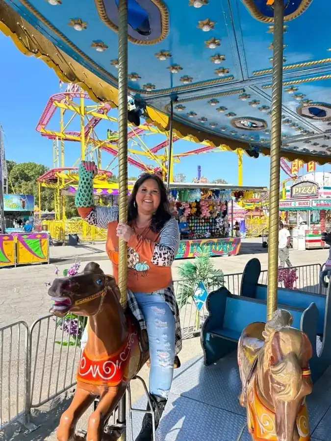 Woman on a carousel wearing a FlexiOH short leg immobilizer